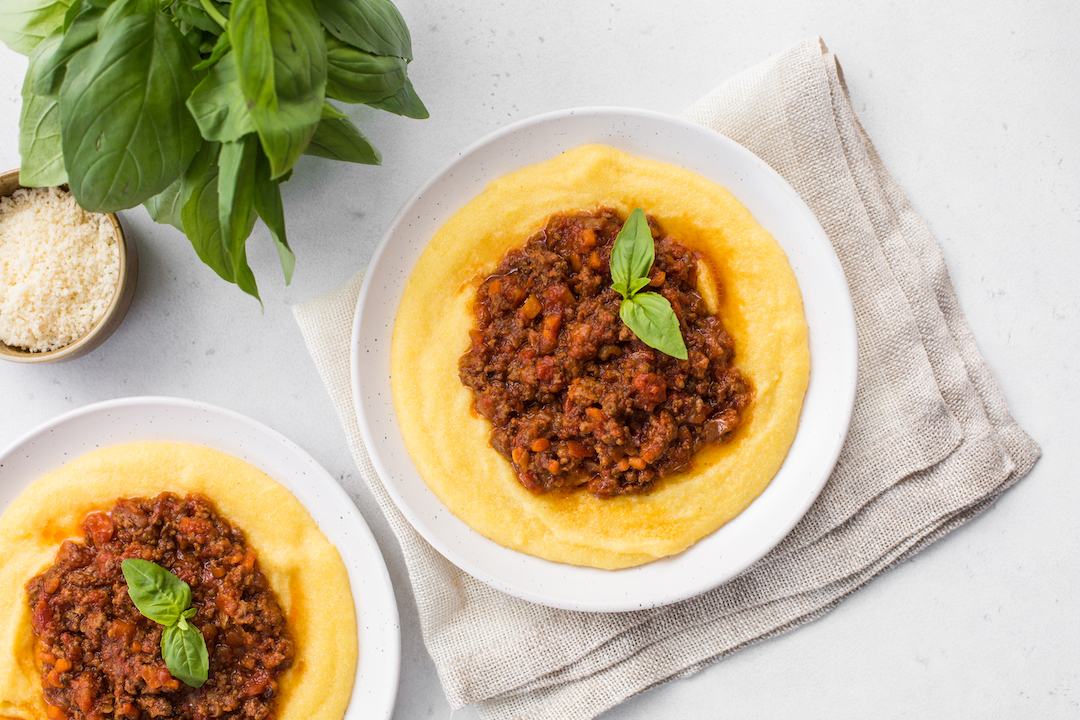Polenta (boiled cornmeal) with meat-based sauce -  ragù alla bolognese.