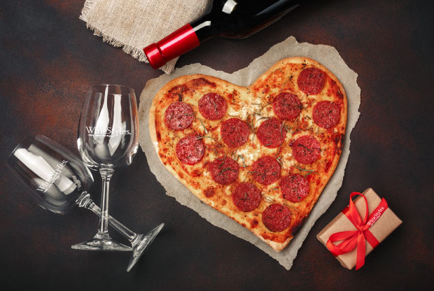 heart shape pizza with wine glasses